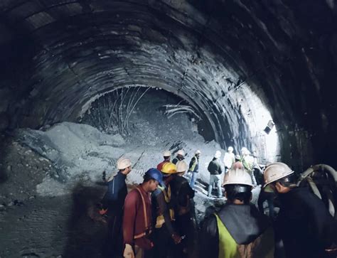 Rescuers dig to reach 40 workers trapped in collapsed road tunnel in north India